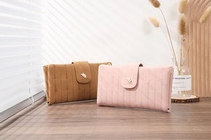Detailed view of the magnetic leaf clasp and striped stitching on the long PU leather wallet