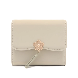 Close-up of cream PU leather tri-fold wallet featuring flower charm and metal pendant detail
