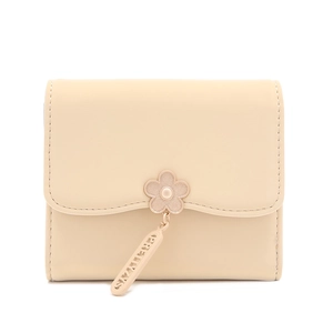 Close-up of cream tri-fold wallet featuring flower clasp and PRETTYZYS metal pendant