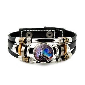 Detail view of dragon graphic on leather bracelet with metal beads and snap button