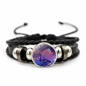 Macro detail of multilayer black leather bracelet featuring a purple dragon glass dome