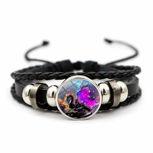 Detail of hand-woven dragon bracelet with purple galaxy glass dome and adjustable cord