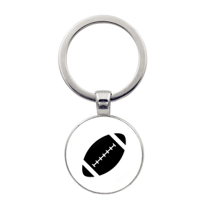Detailed view of silver metal keychain featuring a white round American football pendant
