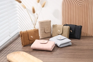 Short faux leather wallets in assorted colors with vertical stitching and leaf metal clasp