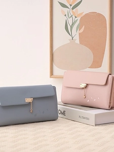 Elegant tri-fold long wallet for women featuring a heart pendant and butterfly accent