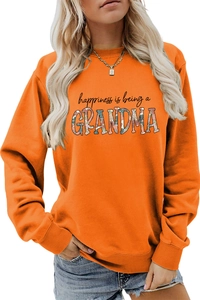 Detail of orange crewneck sweatshirt with happiness is being a grandma floral print