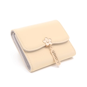 Close-up of beige short tri-fold wallet featuring flower clasp and brand pendant detail