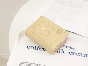 Close-up of beige short PU leather trifold wallet with floral embroidery and pattern