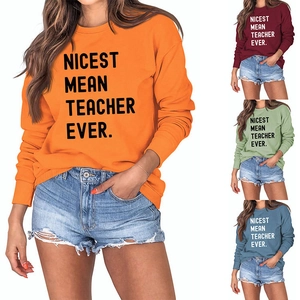 Detail of Nicest Mean Teacher Ever sweatshirts in orange, red, green and blue colors