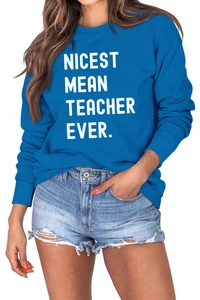Detail view of the Nicest Mean Teacher Ever printed lettering on royal blue sweatshirt