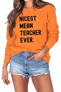 Detail of Nicest Mean Teacher Ever text print on casual orange long sleeve sweatshirt