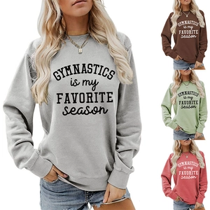 Detail view of colorful gymnastics letter print sweatshirts in grey, pink and green