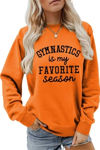 Detail of orange long-sleeve sweatshirt with GYMNASTICS is my FAVORITE season print