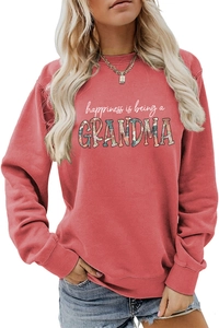 Detail of coral sweatshirt showing grandma floral print and ribbed knit cotton fabric texture