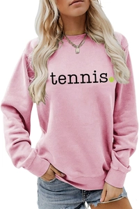 Close-up of pink crewneck sweatshirt featuring black tennis text and green ball graphic