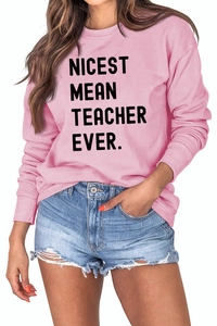 Close-up of pink crewneck sweatshirt with NICEST MEAN TEACHER EVER text and ribbed cuffs