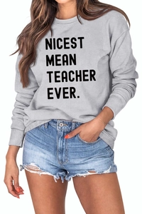 Detail of grey crewneck sweatshirt featuring Nicest Mean Teacher Ever print and ribbed cuffs