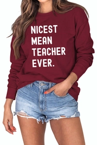 Detail of burgundy sweatshirt showing NICEST MEAN TEACHER EVER text and ribbed cuffs