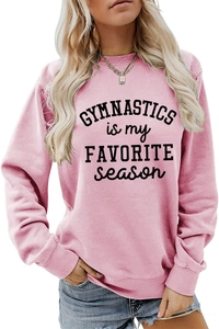 Close-up of pink crewneck sweatshirt with black gymnastics typography and ribbed cuffs
