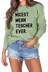 Detail of light green sweatshirt featuring black Nicest Mean Teacher Ever text print