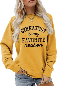 Detail of loose yellow pullover sweatshirt with black gymnastics typography on white background