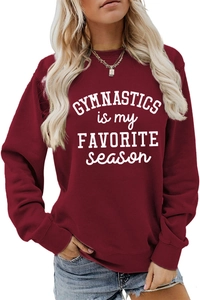 Detail of burgundy sweatshirt showing ribbed cuffs and Gymnastics is my favorite season print