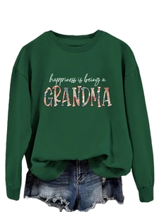 Detail of grandma letter print and vintage floral pattern on green sweatshirt