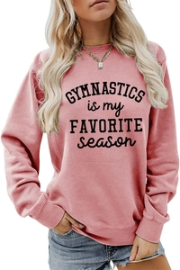 Detail of pink crewneck sweatshirt featuring gymnastics slogan with blue denim jeans