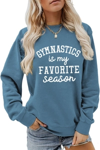 Close-up of blue gymnastics sweatshirt showing ribbed cuffs and white printed lettering