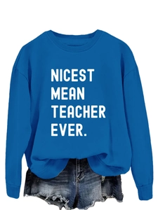 Detail of royal blue sweatshirt featuring white Nicest Mean Teacher Ever slogan text
