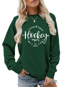 Detail of hockey mom slogan print on a dark green crewneck sweatshirt with ribbed cuffs