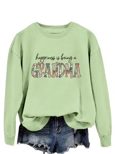 Detail of sage green sweatshirt showing ribbed cuffs and grandma print design