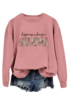 Detail of ribbed cuffs and floral GRANDMA print on pink sweatshirt paired with denim
