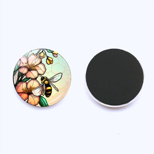 Detail of 25mm round glass fridge magnets with bee and flower illustration and magnetic back