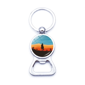 Detail view of sunset cowboy silhouette charm and metal beer bottle opener keychain
