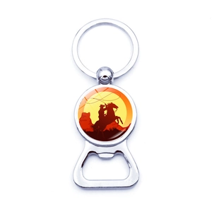 Macro detail of sunset cowboy silhouette keychain and silver metal beer bottle opener
