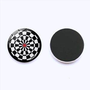 Round glass fridge magnet with dartboard pattern and magnetic back on white background