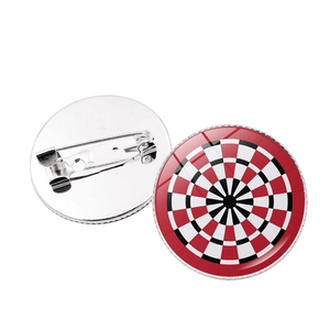 Close-up of a round dartboard brooch with red, white, and black target pattern and back pin