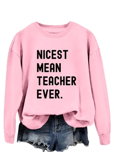 Flat lay of pink sweatshirt with Nicest Mean Teacher Ever text and denim shorts