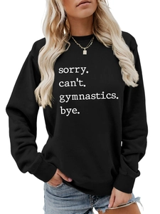 Detail of white typewriter font text on a black long sleeve gymnastics sweatshirt