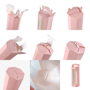 Dettagli di una scatola regalo esagonale rosa con manico e finestra di visualizzazione