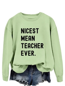 Detail of mint green sweatshirt with Nicest Mean Teacher Ever print and denim shorts