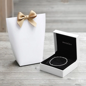 Silver bead bracelet set with premium white jewelry box and bow gift bag on wood