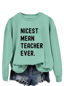 Detail of the ribbed crewneck and NICEST MEAN TEACHER EVER text on light green sweatshirt