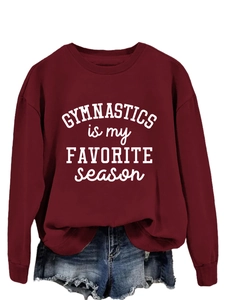Detail view of burgundy sweatshirt featuring white GYMNASTICS is my FAVORITE season print