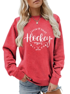 Detail of red crewneck sweatshirt with white hockey mom typography and graphic