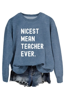 Detail of the white slogan printed on fog blue sweatshirt paired with denim shorts