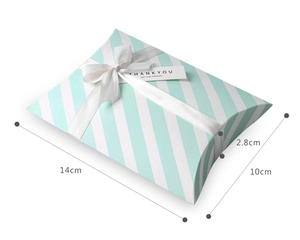 Detail of mint green striped pillow gift box with white ribbon and thank you tag