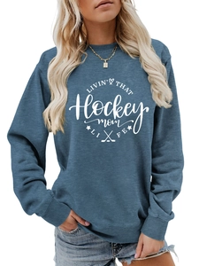 Close-up of blue crewneck sweatshirt with white hockey mom life printed design and graphics