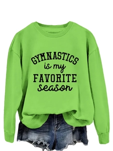 Detail showing gymnastics slogan print on neon green crewneck long sleeve sweatshirt